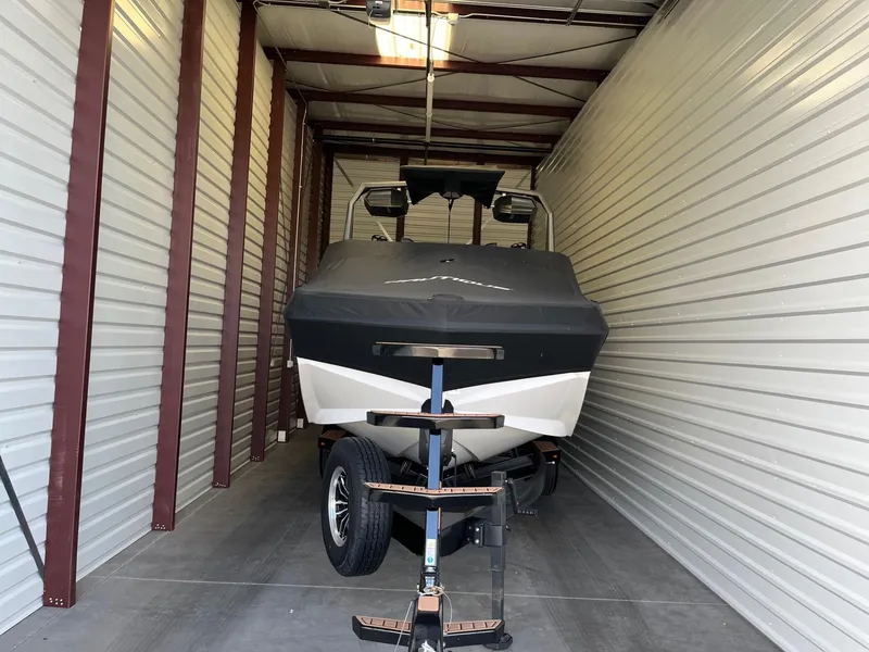 Slide: The Image of 2023 Nautique Super Air G23 boat stored in a garage. - 94