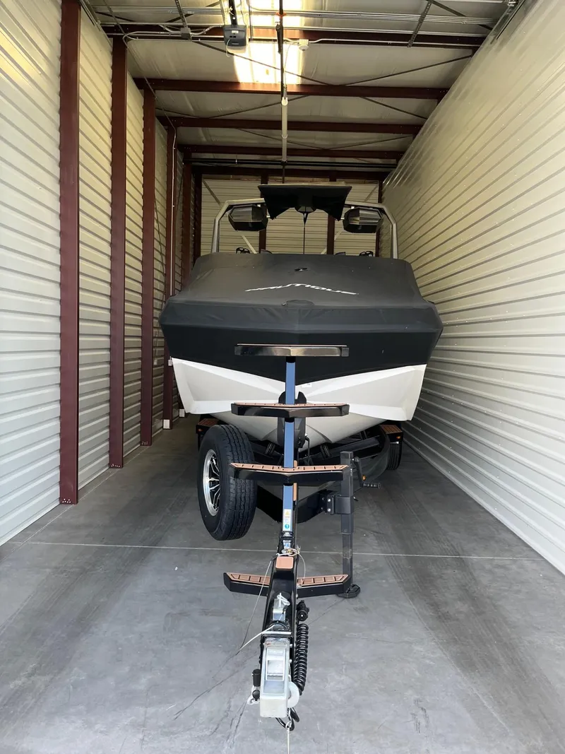 Slide: The Image of 2023 Nautique Super Air G23 boat stored in a garage. - 95