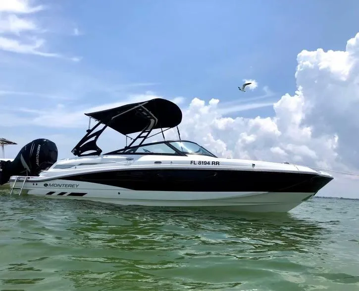 Slide: The Image of 2018 Monterey M45 boat on water under blue sky with clouds. - 0