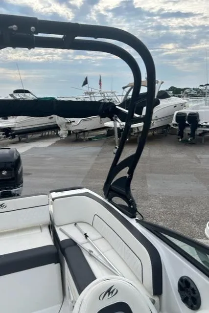 Slide: The Image of 2018 Monterey M45 boat interior with seating, docked at marina under cloudy sky. - 16
