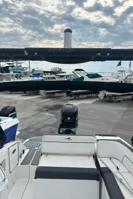 Slide: The Image of Monterey M45 boat, 2018 model, docked with other boats under a cloudy sky. - 17
