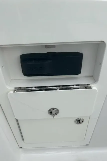 Slide: The Image of 2018 Monterey M45 storage compartment with secure latch and black cover. - 22