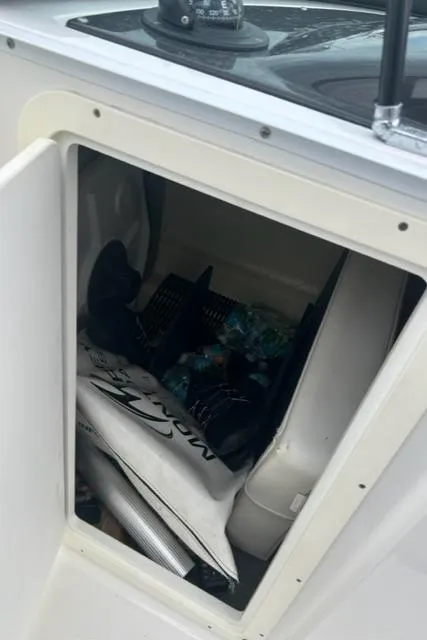 Slide: The Image of Open storage compartment on 2018 Monterey M45 boat, containing various items. - 29