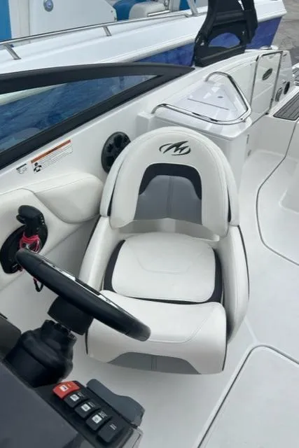 Slide: The Image of 2018 Monterey M45 boat interior with white captain's seat and steering wheel. - 30