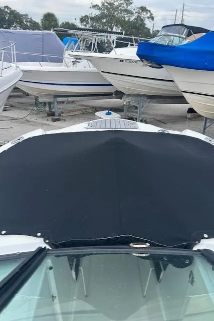 Slide: The Image of 2018 Monterey M45 boat with black cover in a marina. - 42