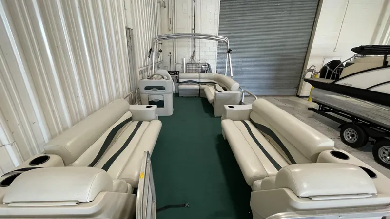 Slide: The Image of 1991 Sweetwater 2350 pontoon boat interior with spacious seating and green carpet. - 3