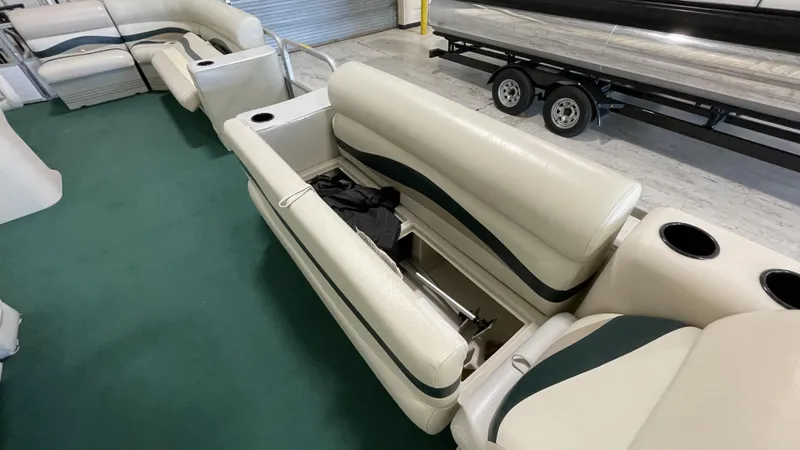 Slide: The Image of Sweetwater 2350 boat interior with green carpet and white seating, 1991 model. - 7