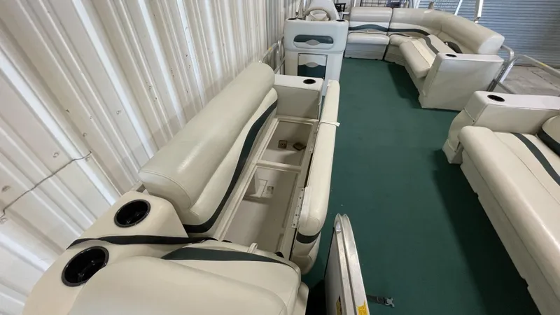 Slide: The Image of Interior of 1991 Sweetwater 2350 pontoon boat with white seating and green carpet. - 8