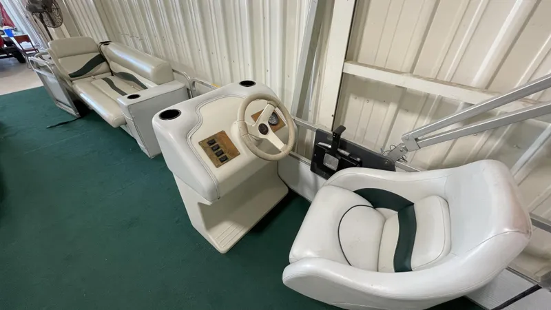 Slide: The Image of Interior of 1991 Sweetwater 2350 boat with white seating and steering console. - 9
