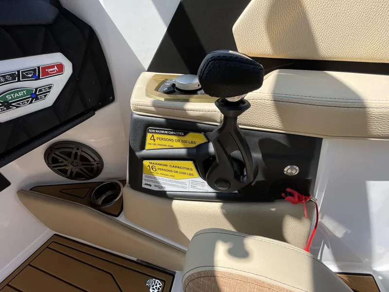 Slide: The Image of 2025 Nautique Super Air S S23 boat interior controls and seating detail. - 13