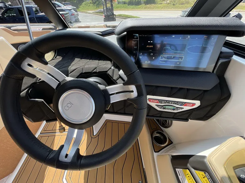 Slide: The Image of 2025 Nautique Super Air S S23 dashboard with steering wheel and touchscreen display. - 27