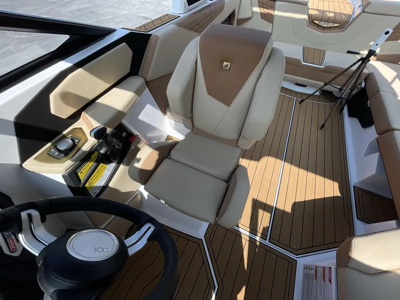 Slide: The Image of 2025 Nautique Super Air S S23 interior with tan leather seats and modern controls. - 28