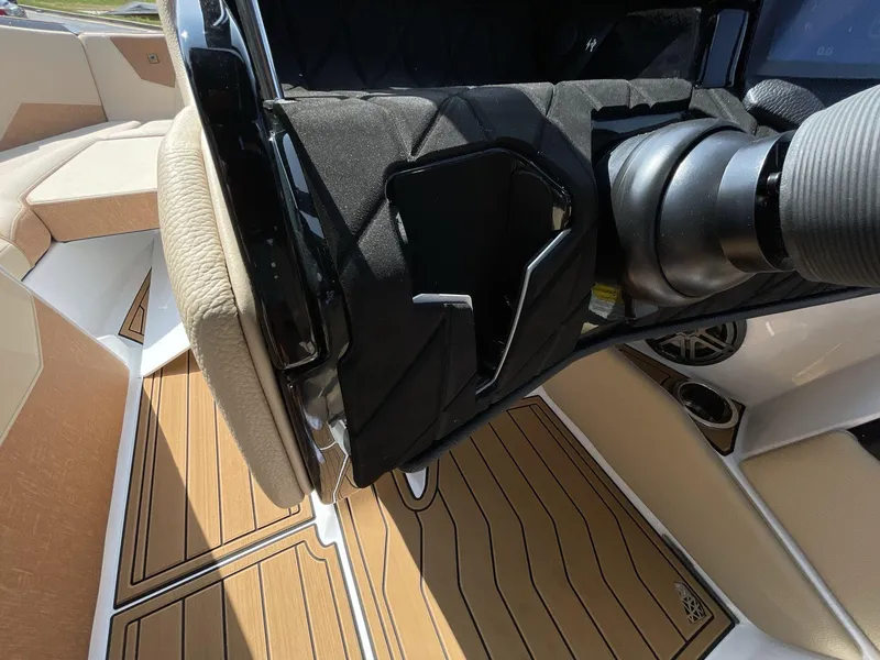 Slide: The Image of 2025 Nautique Super Air S S23 interior with tan upholstery and sleek dashboard design. - 29