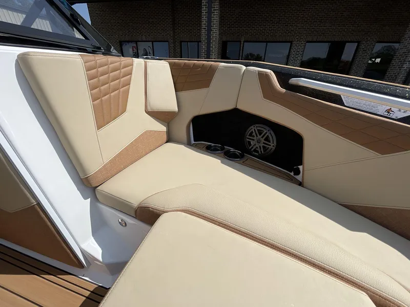 Slide: The Image of 2025 Nautique Super Air S S23 interior with tan and brown upholstery. - 31
