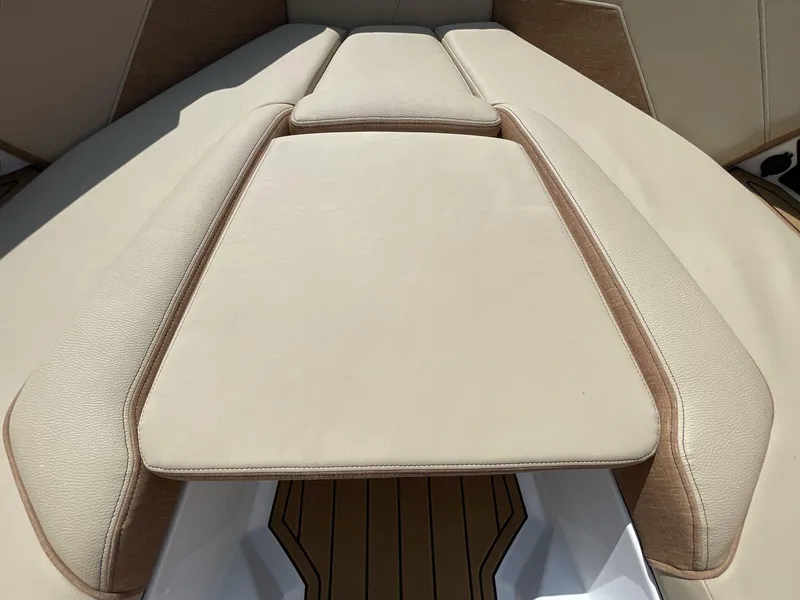 Slide: The Image of 2025 Nautique Super Air S S23 boat interior with beige upholstery. - 32