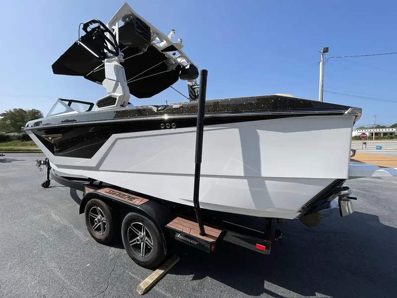 Slide: The Image of 2025 Nautique Super Air S S23 boat on trailer, sleek design, black and white color scheme. - 33