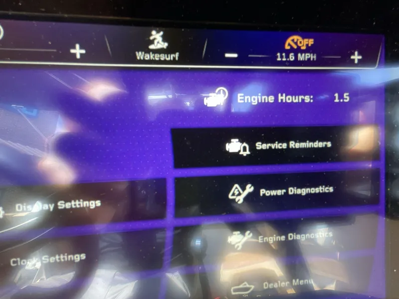 Slide: The Image of 2025 Nautique Super Air S S23 dashboard displaying engine hours and diagnostics options. - 4