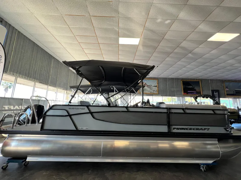 The Image of 2024 Princecraft Quorum 23 RL pontoon boat in showroom, side view. - 0