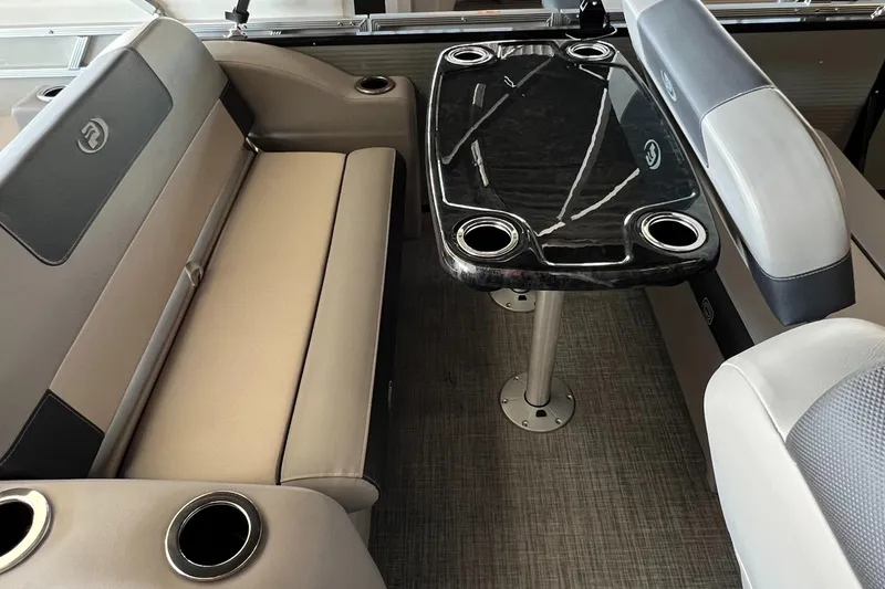 Slide: The Image of 2024 Princecraft Quorum 23 RL interior with seating and sleek table design. - 10