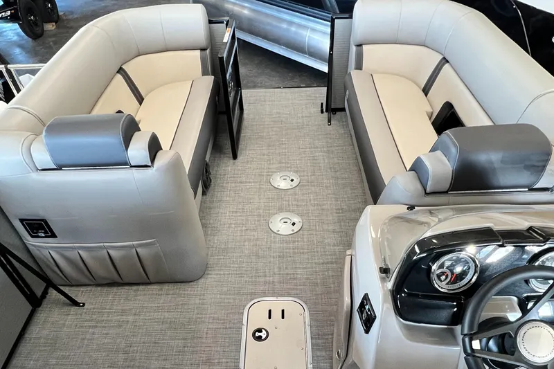 Slide: The Image of 2024 Princecraft Quorum 23 RL pontoon boat interior with plush seating and modern dashboard. - 11