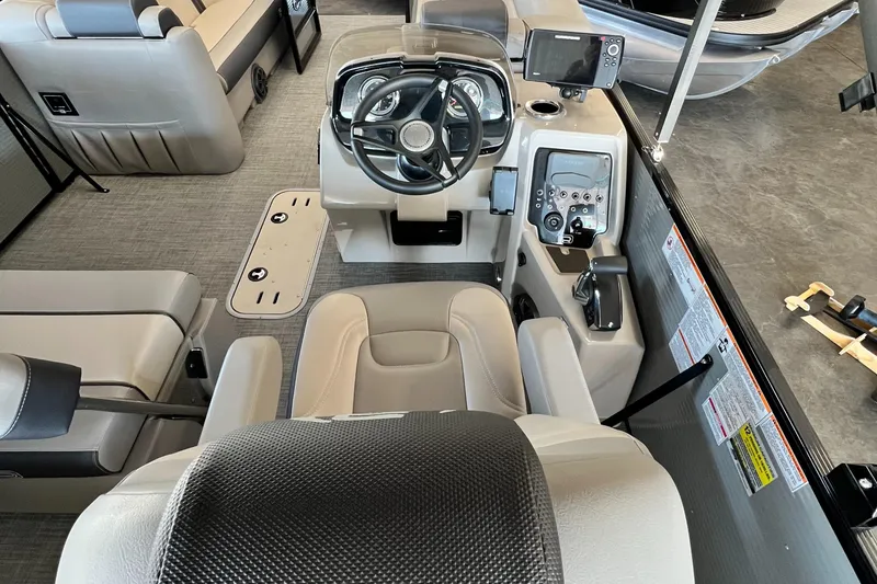 Slide: The Image of 2024 Princecraft Quorum 23 RL boat interior with steering console and seating. - 9