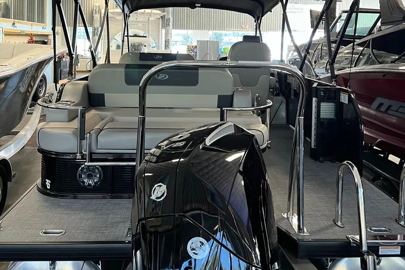 Slide: The Image of 2024 Princecraft Quorum 23 RL pontoon boat interior with seating and canopy. - 11