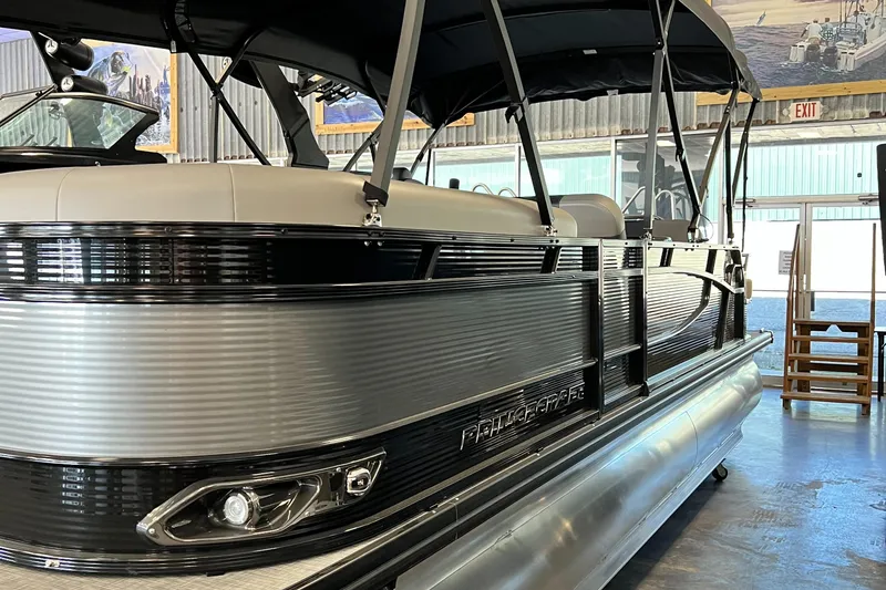 Slide: The Image of 2024 Princecraft Quorum 23 RL pontoon boat interior with seating and privacy curtain. - 12