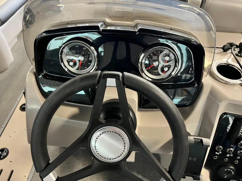 Slide: The Image of 2024 Princecraft Quorum 23 RL pontoon boat interior with seating and helm station. - 9