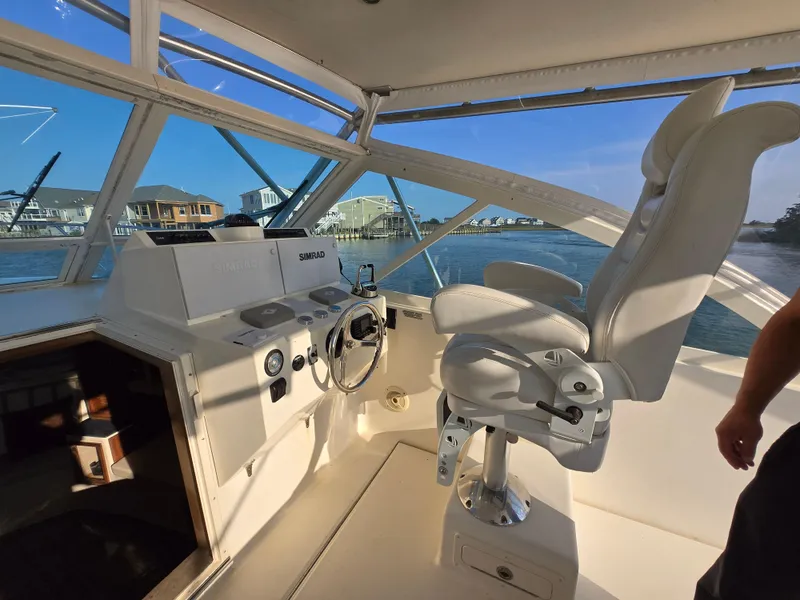 Slide: The Image of 2007 Carolina Classic 35 boat helm with captain's chair and waterfront view. - 12