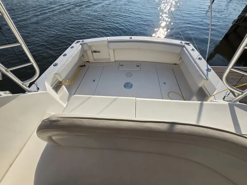 Slide: The Image of 2007 Carolina Classic 35 boat deck with seating, docked by the water. - 14