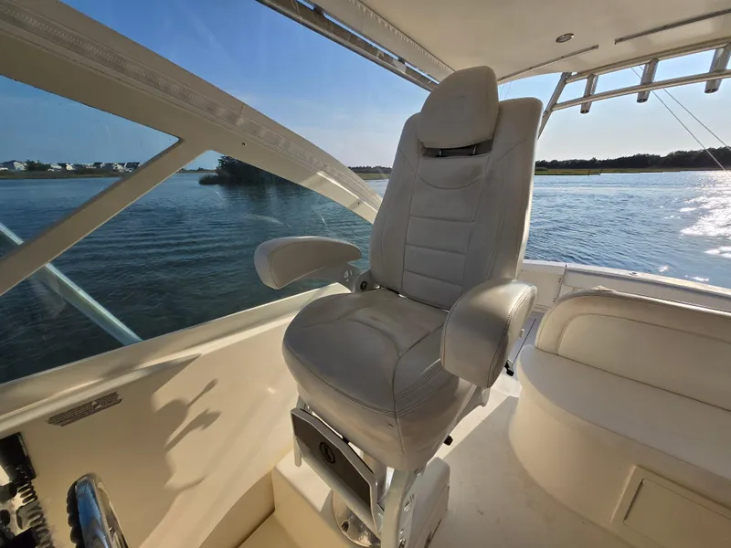 Slide: The Image of Captain's chair on 2007 Carolina Classic 35 boat, overlooking serene water view. - 15