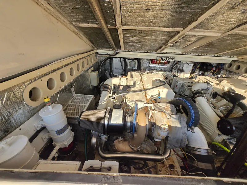 Slide: The Image of Engine room of a 2007 Carolina Classic 35 boat, showcasing mechanical components and layout. - 18