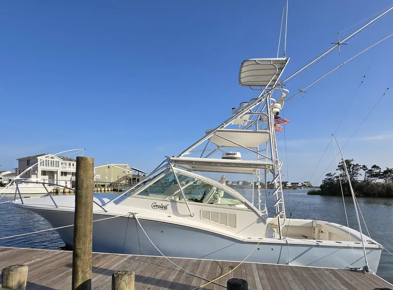 Slide: The Image of 2007 Carolina Classic 35 boat docked at marina under clear blue sky. - 2