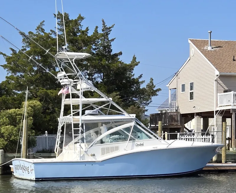 Slide: The Image of 2007 Carolina Classic 35 boat docked near waterfront house. - 22