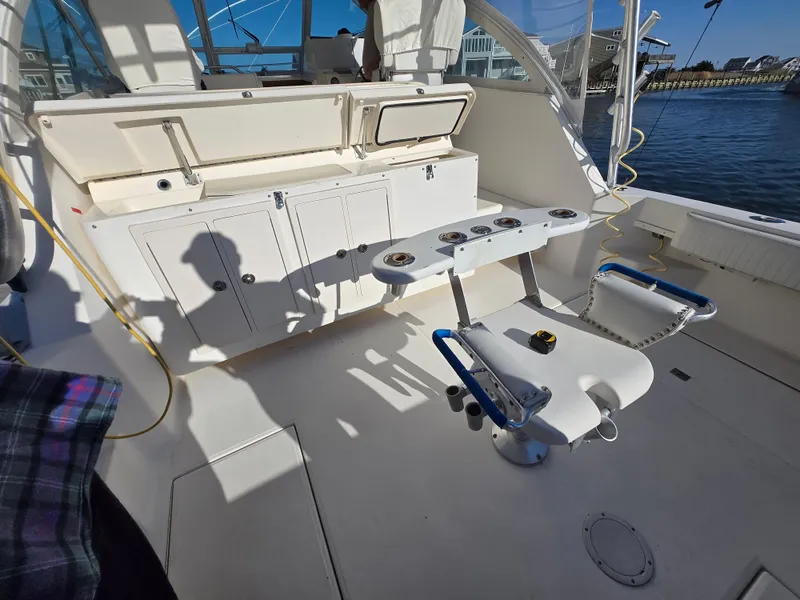 Slide: The Image of 2007 Carolina Classic 35 boat interior with fishing rod holders and seating. - 23