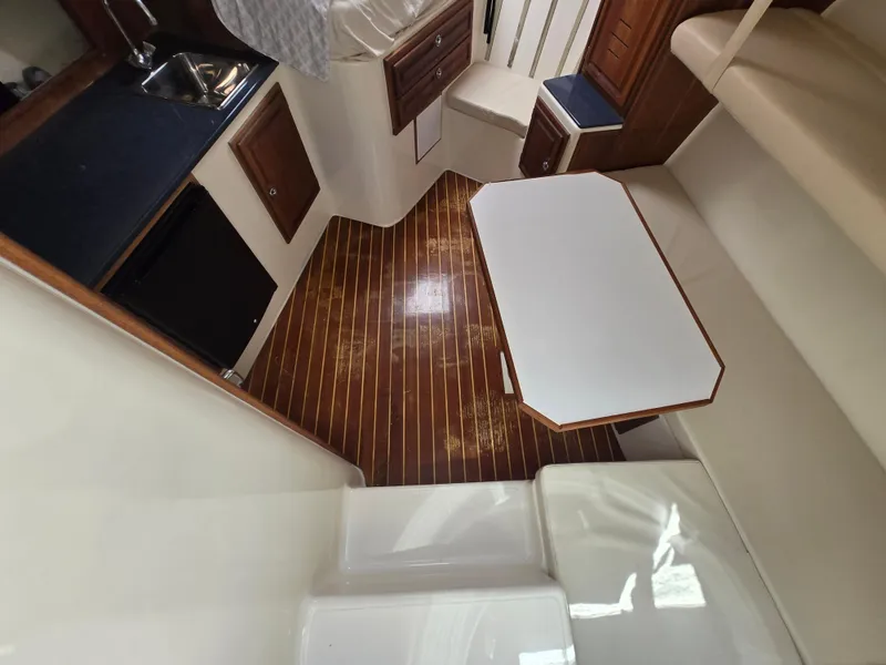 Slide: The Image of Interior of 2007 Carolina Classic 35 boat with wood flooring and compact kitchen area. - 33