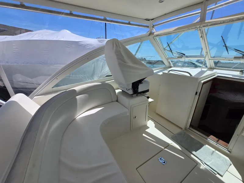 Slide: The Image of 2007 Carolina Classic 35 boat interior with seating and helm, featuring a covered console. - 36