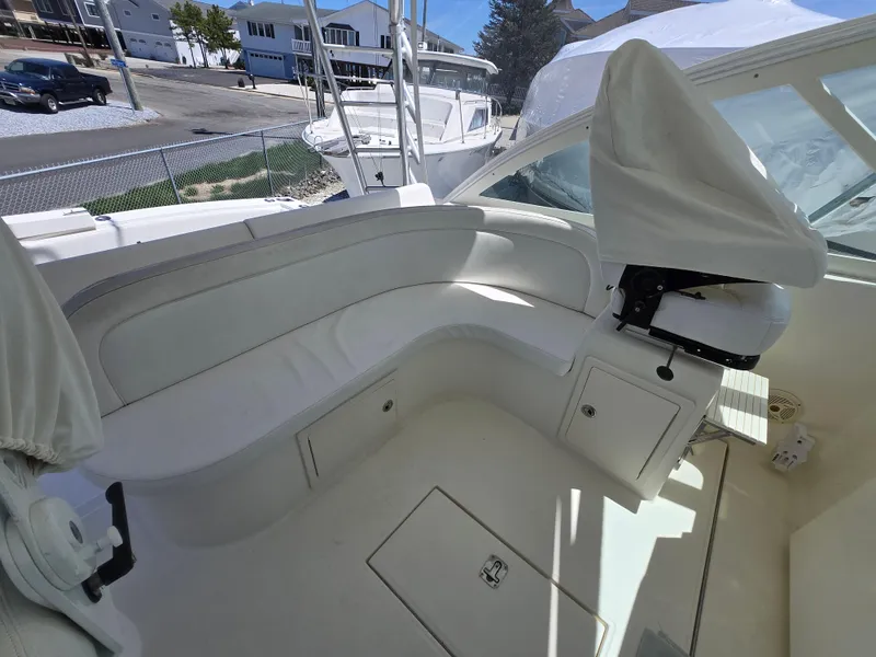 Slide: The Image of 2007 Carolina Classic 35 boat interior with white seating and covered controls. - 37