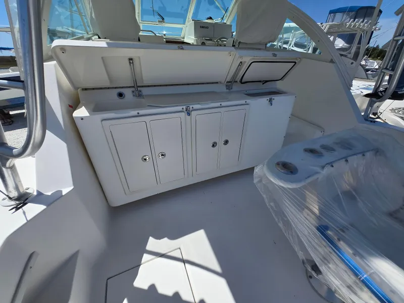 Slide: The Image of 2007 Carolina Classic 35 boat interior with storage cabinets and seating area. - 41