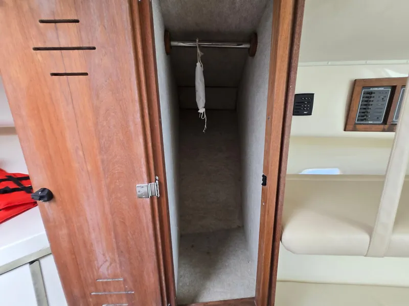 Slide: The Image of 2007 Carolina Classic 35 interior closet with wooden door and beige upholstery. - 42
