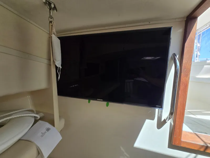 Slide: The Image of Flat-screen TV inside 2007 Carolina Classic 35 boat cabin, near window and handrail. - 43