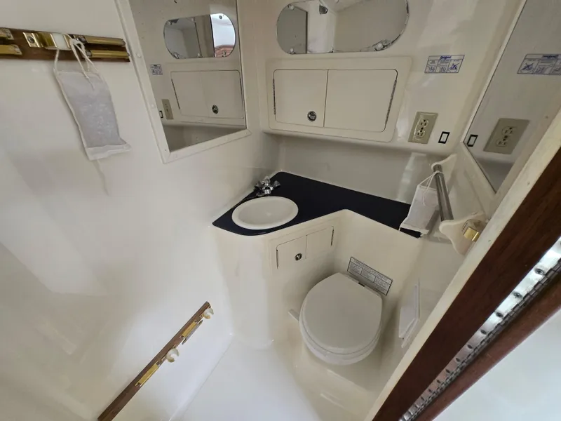 Slide: The Image of 2007 Carolina Classic 35 boat bathroom with sink, toilet, and storage cabinets. - 44