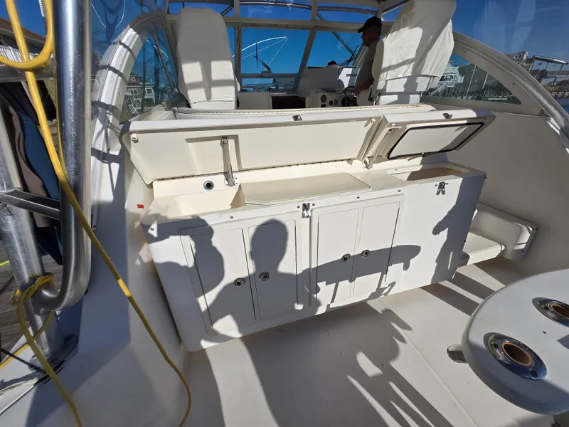 Slide: The Image of 2007 Carolina Classic 35 boat interior with open storage compartments and seating area. - 7