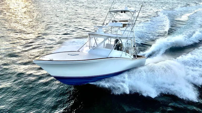 The Image of 2004 Predator 35 boat cruising on open water, creating dynamic waves. - 1