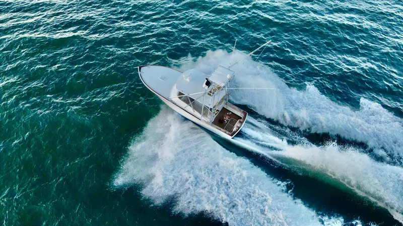Slide: The Image of Aerial view of 2004 Predator 35 boat speeding on ocean waves. - 11