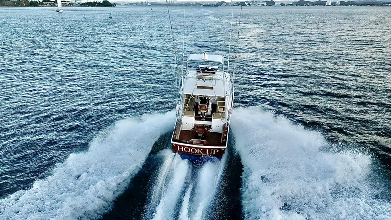 Slide: The Image of A 2004 Predator 35 boat cruising swiftly on open water, creating a dynamic wake. - 12