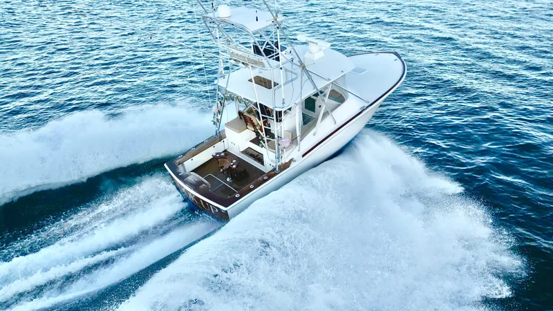 Slide: The Image of A 2004 Predator 35 boat cruising swiftly on open water. - 13
