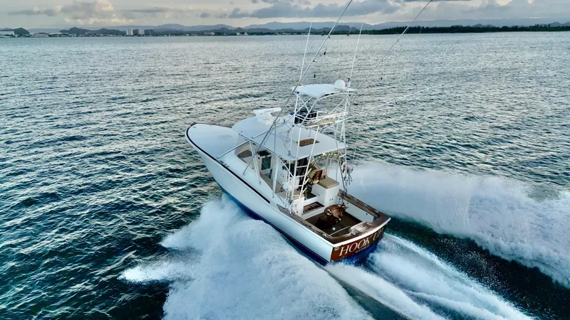 Slide: The Image of A 2004 Predator 35 boat cruising swiftly on open water. - 14