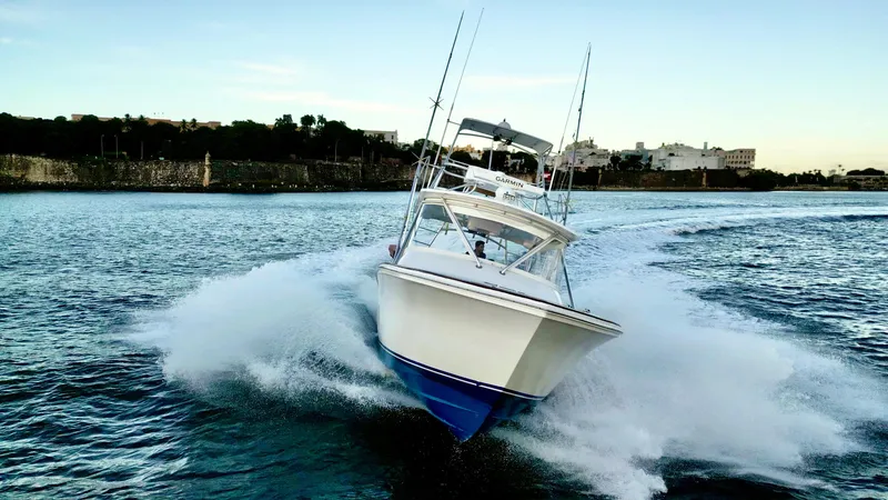 Slide: The Image of A 2004 Predator 35 boat speeding on water, creating a dynamic splash. - 17