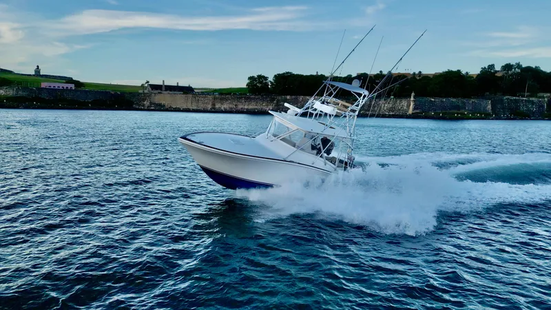 Slide: The Image of 2004 Predator 35 boat cruising swiftly on a scenic waterway. - 18